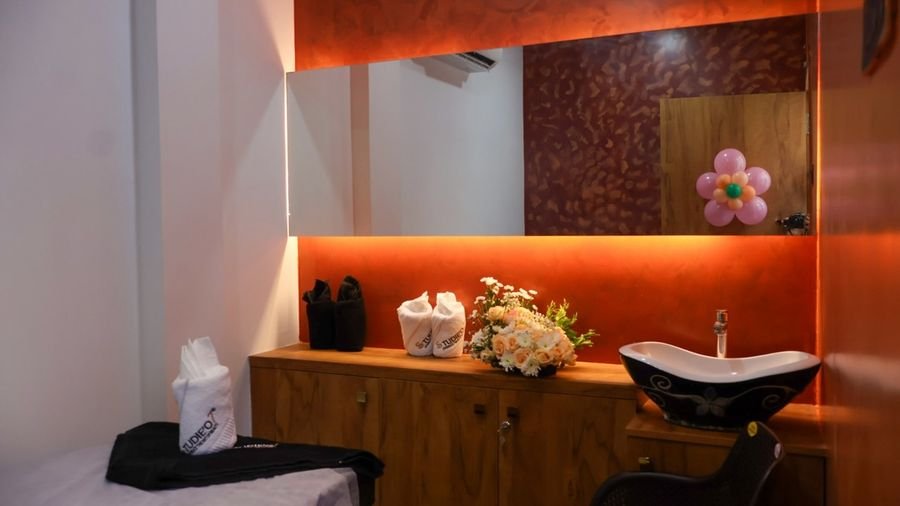 Treatment room with warm amber lighting and mirror