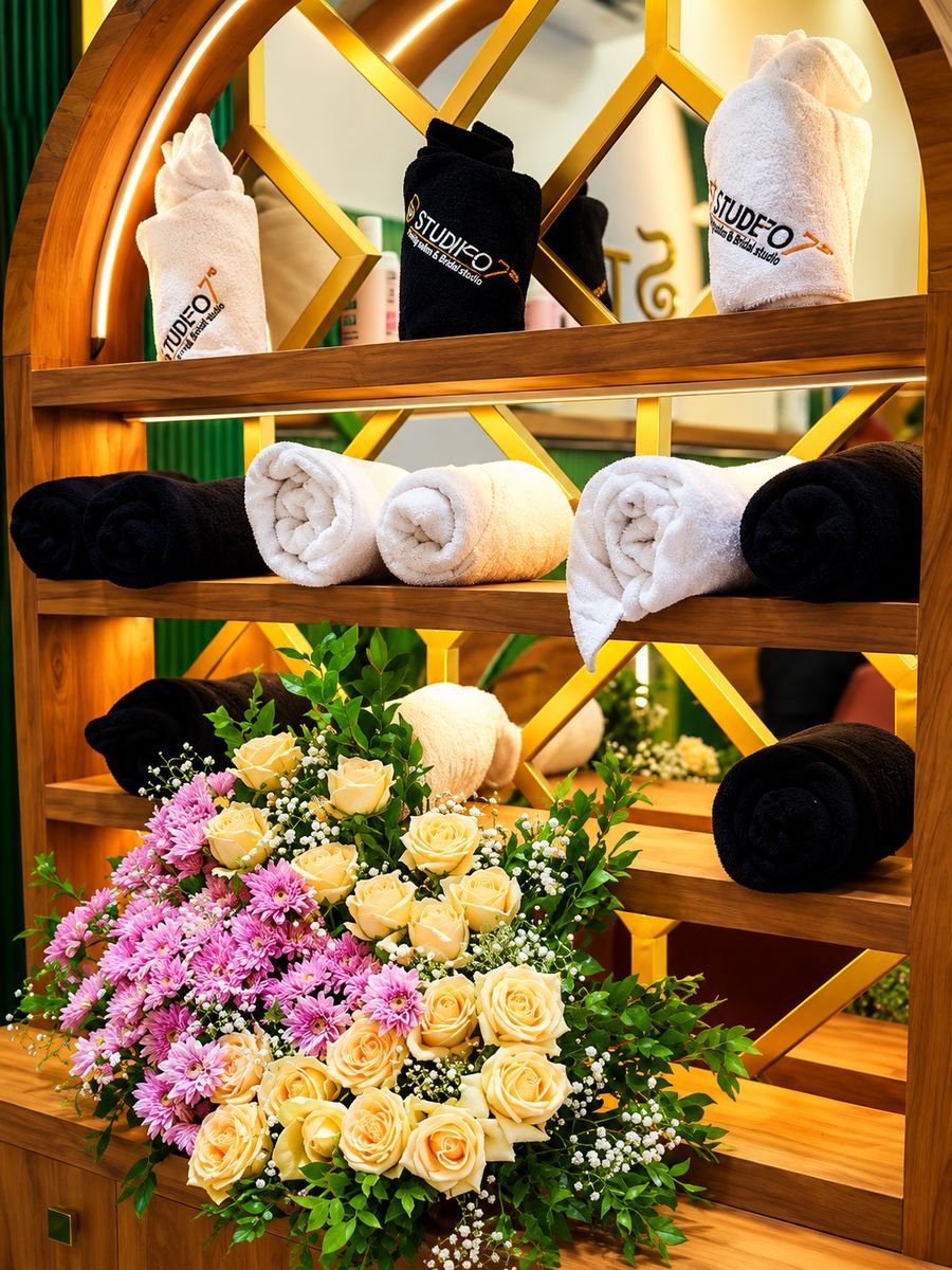 Branded towels and fresh flowers on the arched display shelf